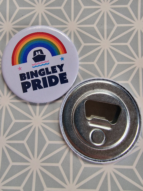 Bottle opener with rainbow design and 'Bingley Pride' text on a geometric patterned surface